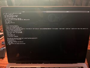 A photo of a Macbook Pro with a full screen iTerm2 window on it that the output for `curl -v google.com` on it.